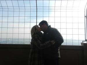 A kiss on top of the Tour de Eiffel (Eiffel Tower, for you non-French speakers).